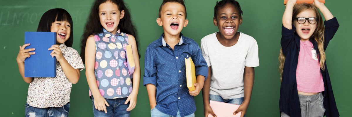 Image of five smiling children; courtesy of Shutterstock.